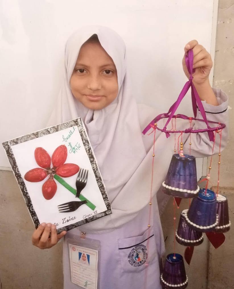 Student holding craft project