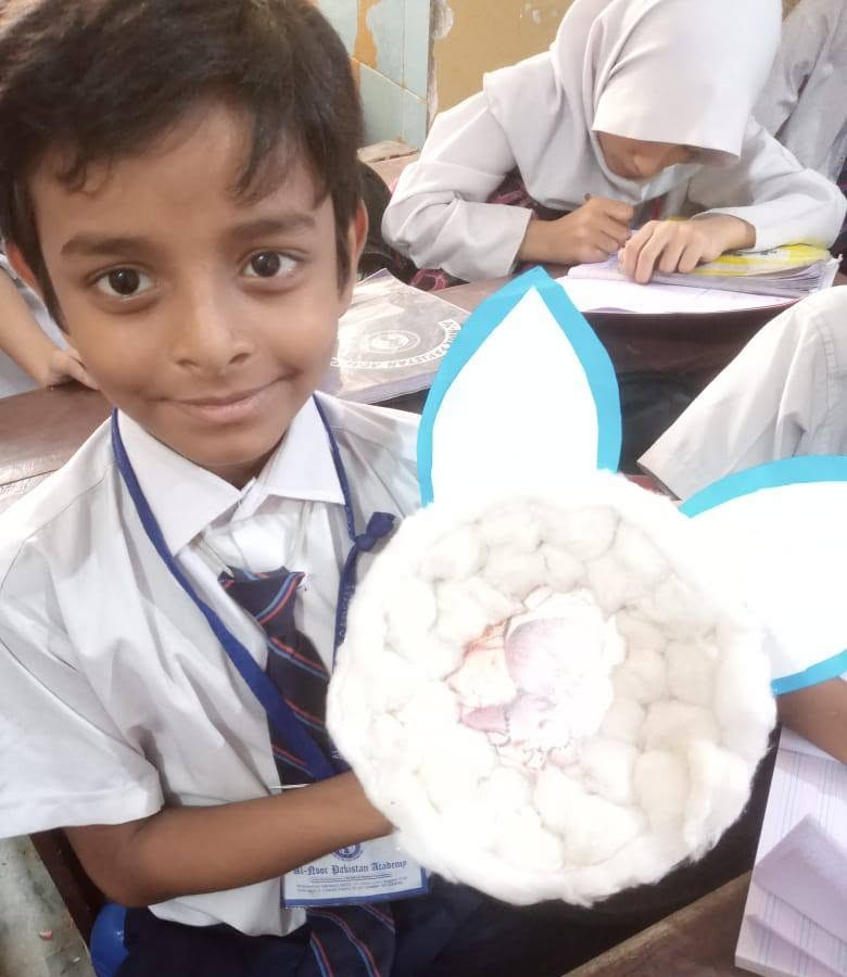 Student displaying sheep craft